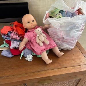 Bitty Baby and bear with a bag full of outfits